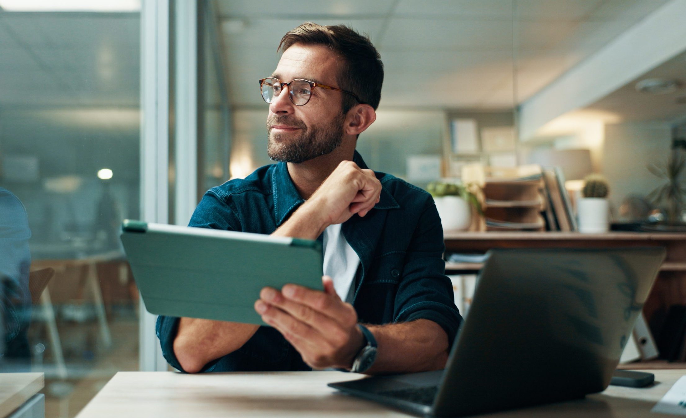 Tablet, thinking and smile with business man in office for planning, ui designer and app review. Developer solutions, reflection and research with person in agency for project idea and startup.